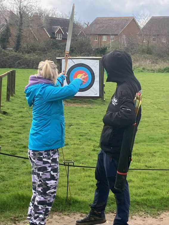 A young learner having a go on an archery range