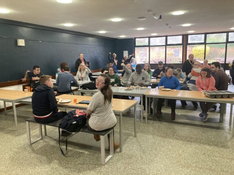 A group of staff and learners enjoying lunch at a canteen