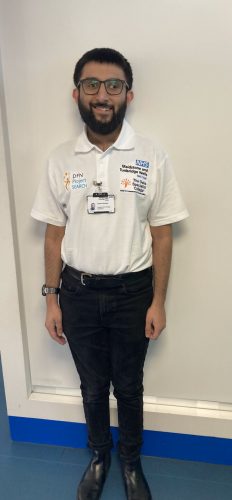 Young learner smiling, dressed in Maidstone Hospital polo shirt